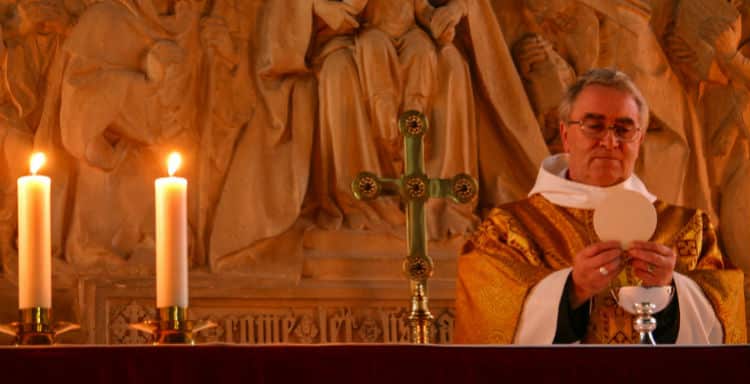 Catholic Priest Giving Communion