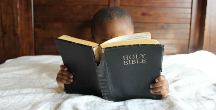 Young Child Holding Bible