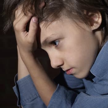 frustrated boy with hands in hair