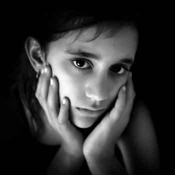 sad girl with head in hands