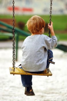 young boy on swing
