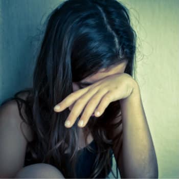 young depressed girl in corner